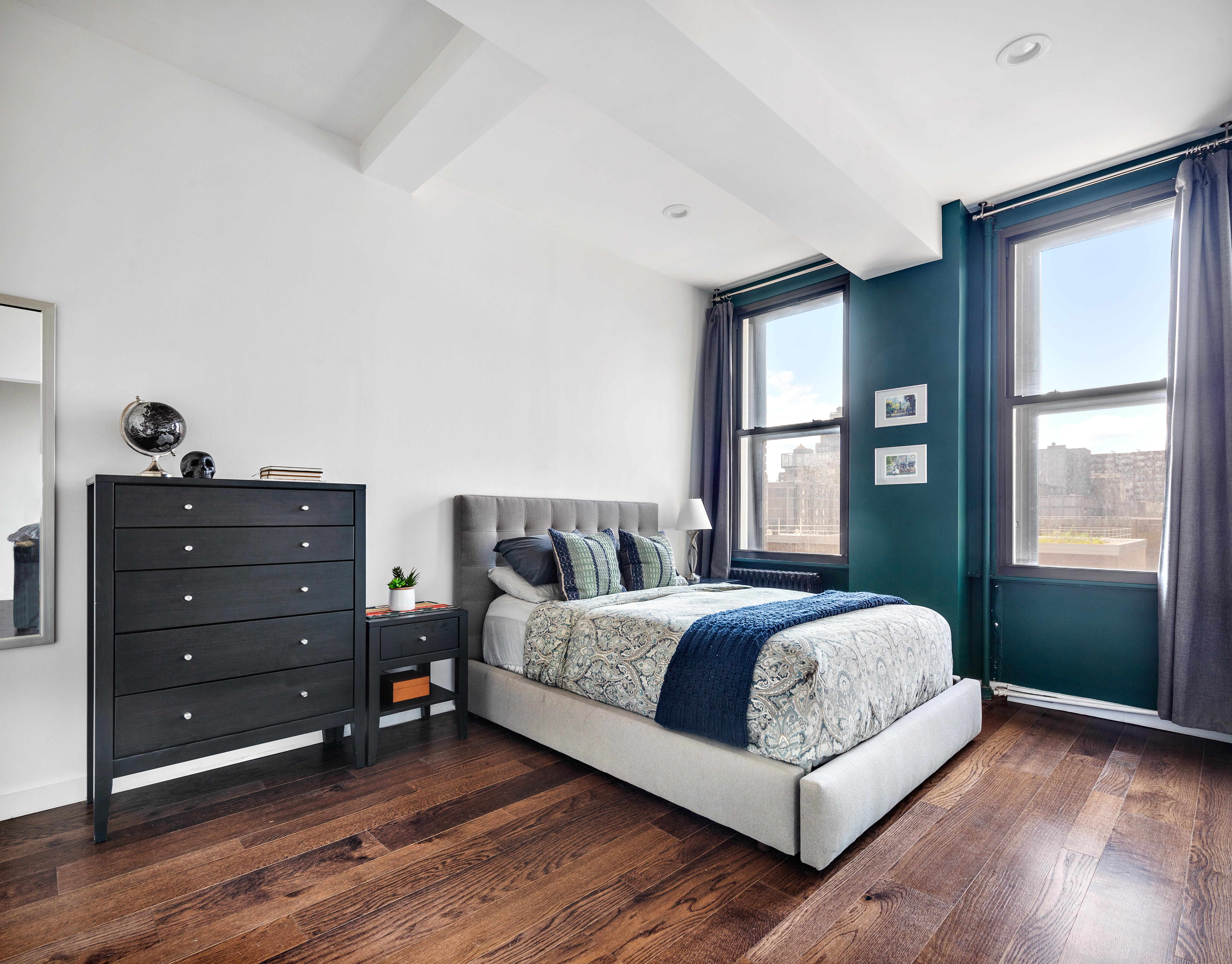 315 7th Avenue, Unit 9B Manhattan, NY 10001 - Photo 5 of 8 a living room with a bed window and dresser