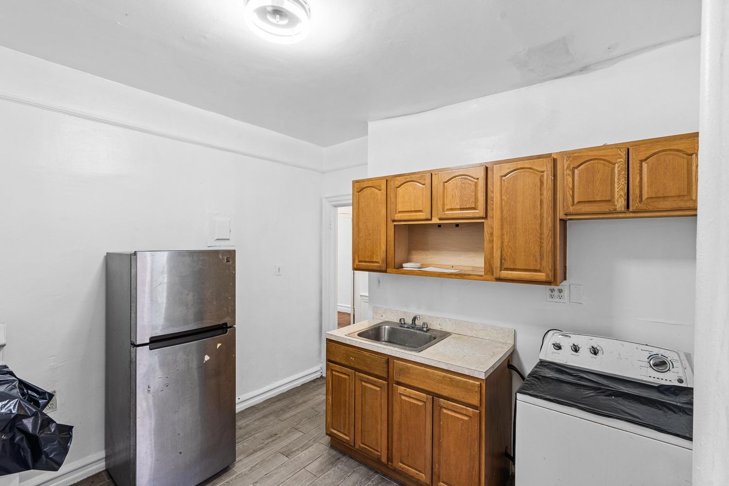 a kitchen with a refrigerator sink and stove