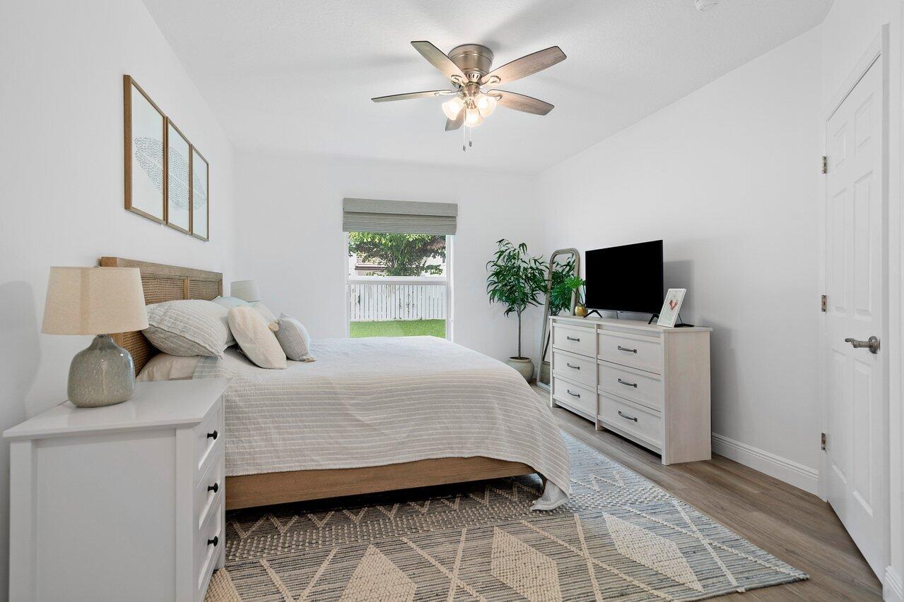 1182 Canoe Point Delray Beach, FL 33444 - Photo 15 of 46 a bedroom with a bed and a flat screen tv