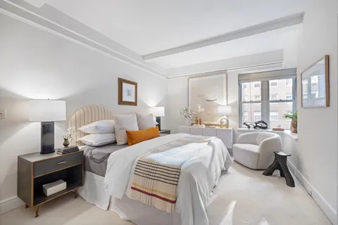 a bedroom with two beds and a large window