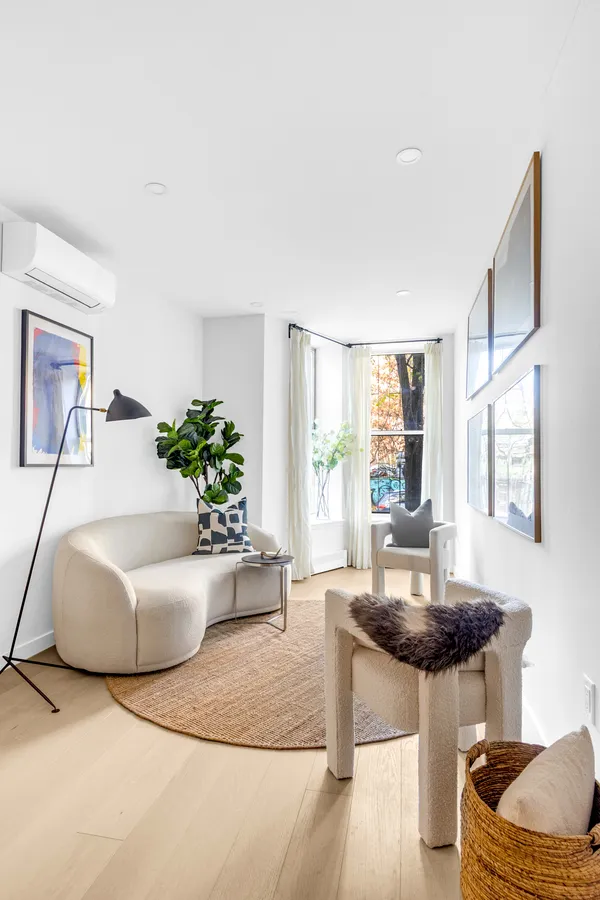 a living room with furniture and a potted plant
