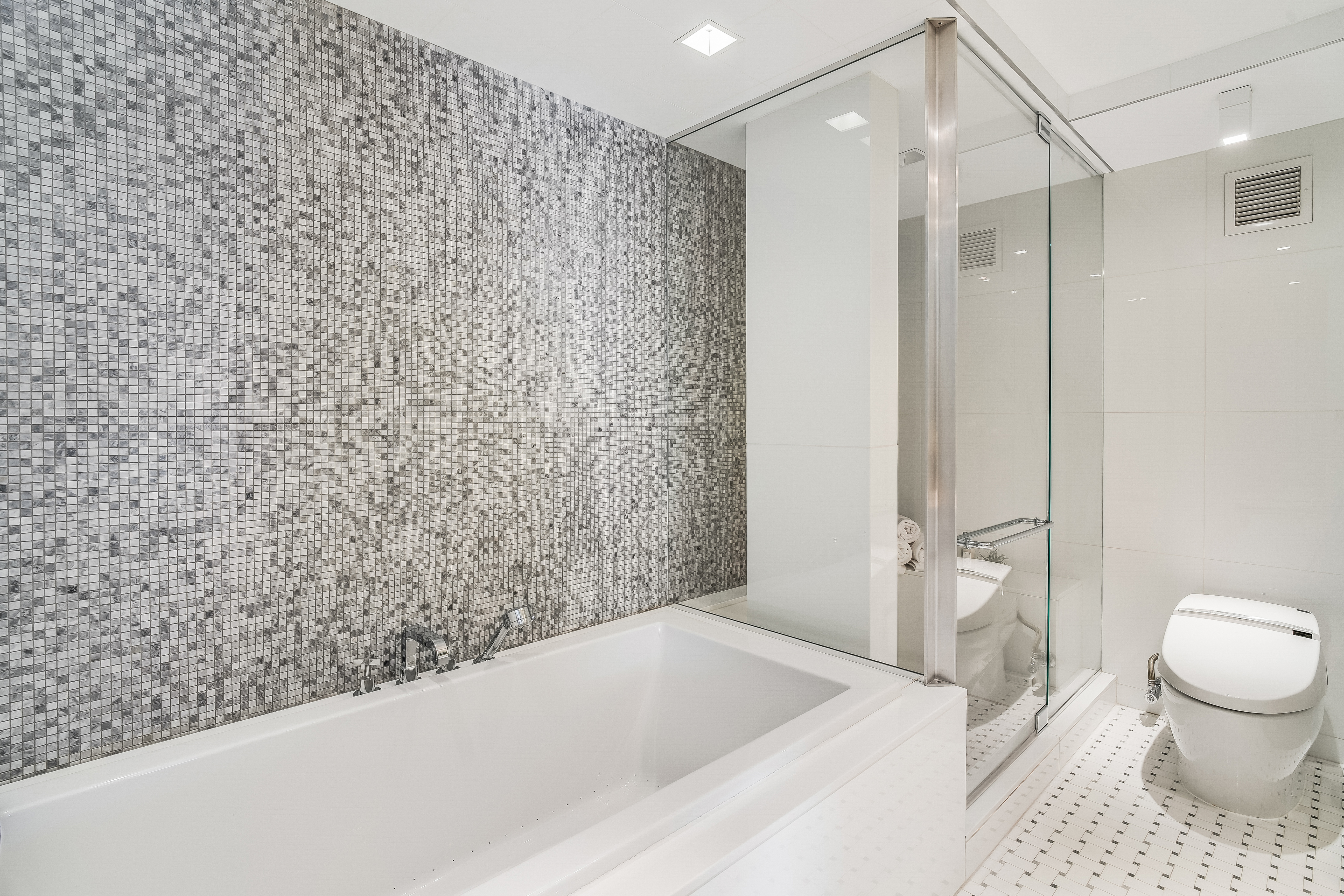 1 5th Avenue, Unit 5GH Manhattan, NY 10003 - Photo 15 of 26 a bathroom with a bathtub and toilet