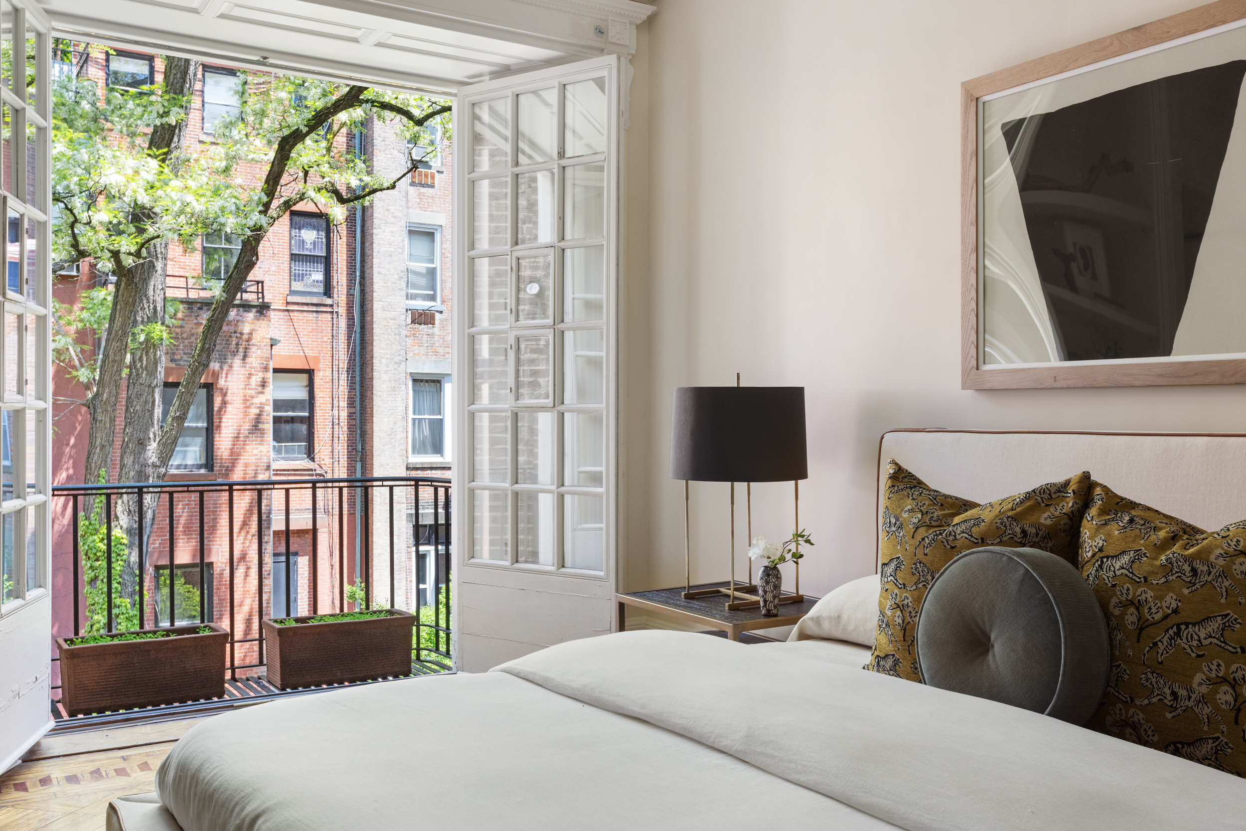 37 West 70th Street Manhattan, NY 10023 - Photo 20 of 41 a bedroom with a bed a flat screen tv and a large window