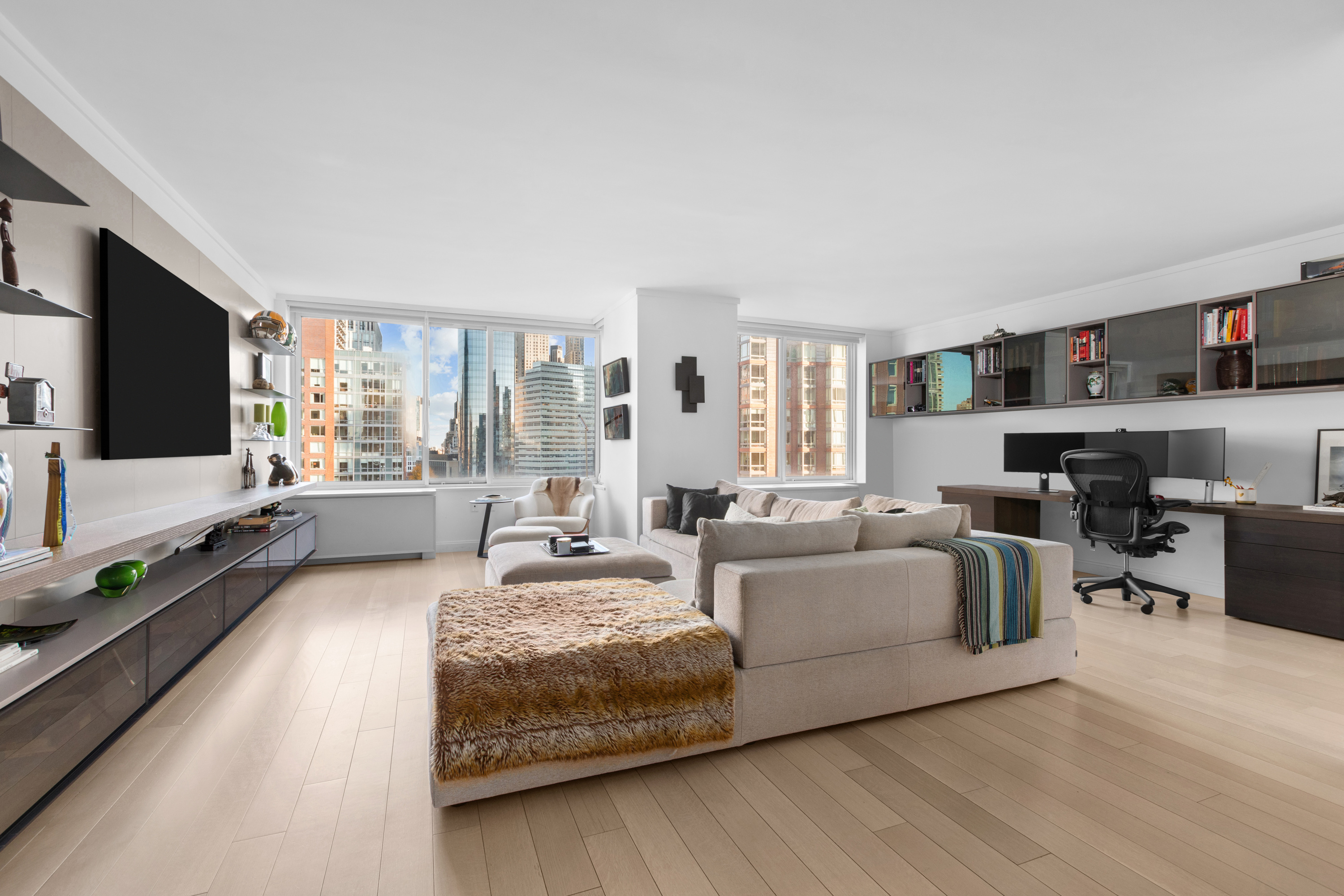 212 Warren Street, Unit 20A Manhattan, NY 10282 - Photo 13 of 23 a living room with furniture and a flat screen tv