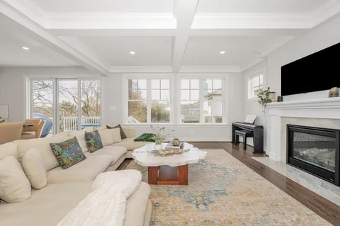 a kitchen with stainless steel appliances granite countertop a sink a stove a refrigerator and island with wooden floor