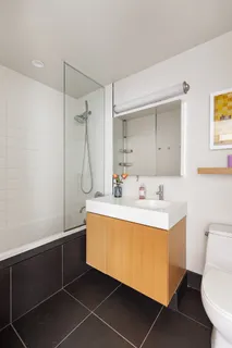 a bathroom with a sink mirror vanity and toilet