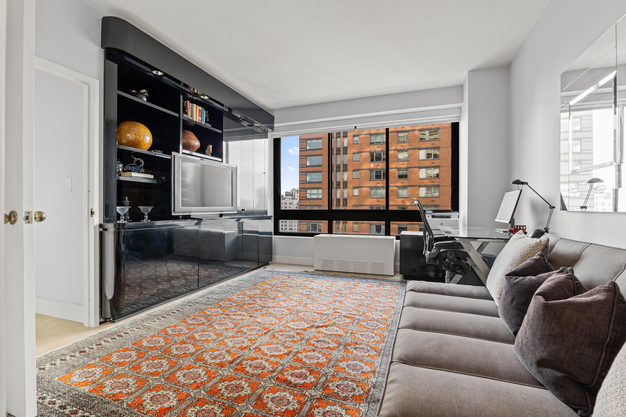 167 East 61st Street, Unit 20E Manhattan, NY 10065 - Photo 18 of 24 a living room with furniture and a flat screen tv