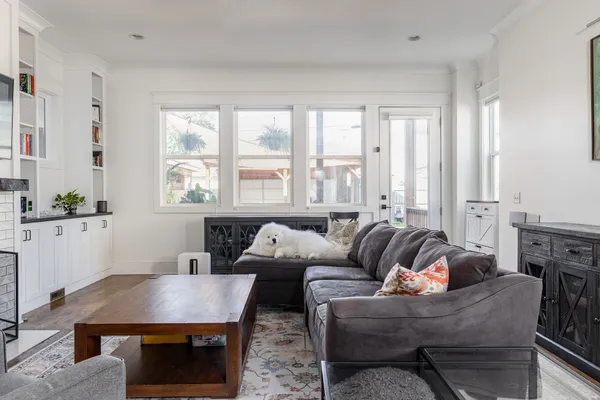 a living room with furniture a flat screen tv and a fireplace