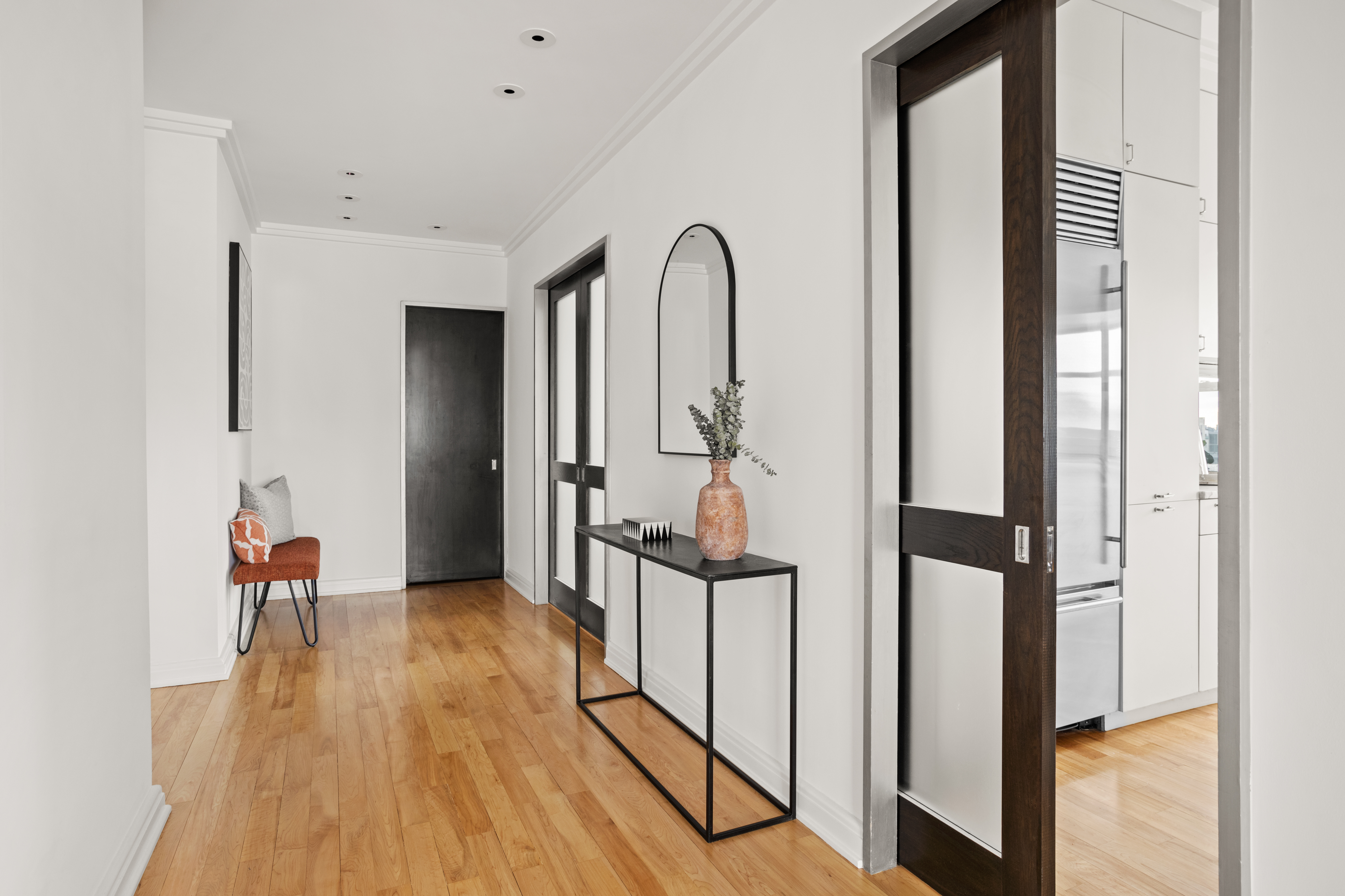 2 5th Avenue, Unit PHDF Manhattan, NY 10011 - Photo 5 of 24 a view of a hallway with wooden floor and furniture