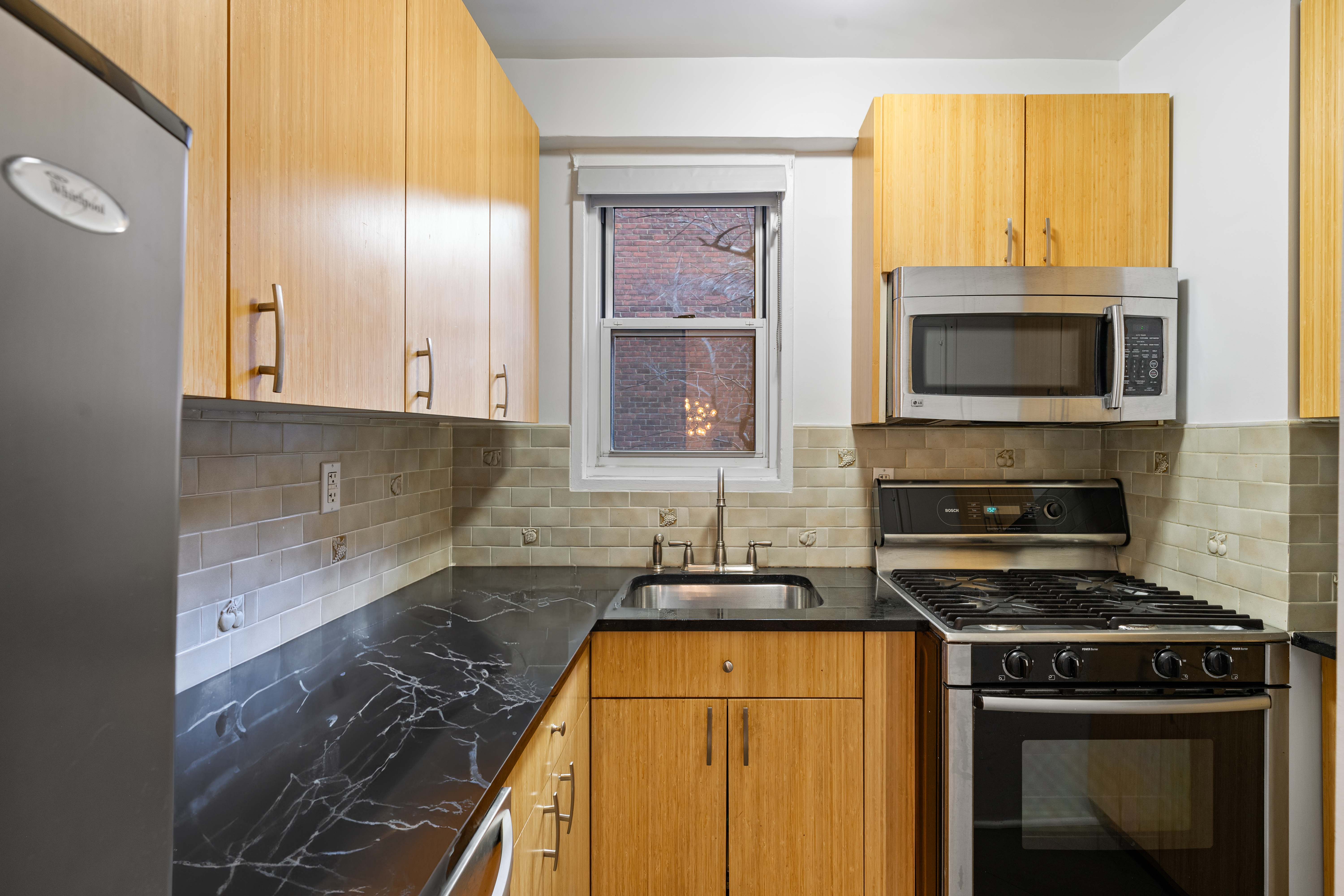 14 Horatio Street, Unit 2J Manhattan, NY 10014 - Photo 4 of 9 a kitchen with a stove and a microwave