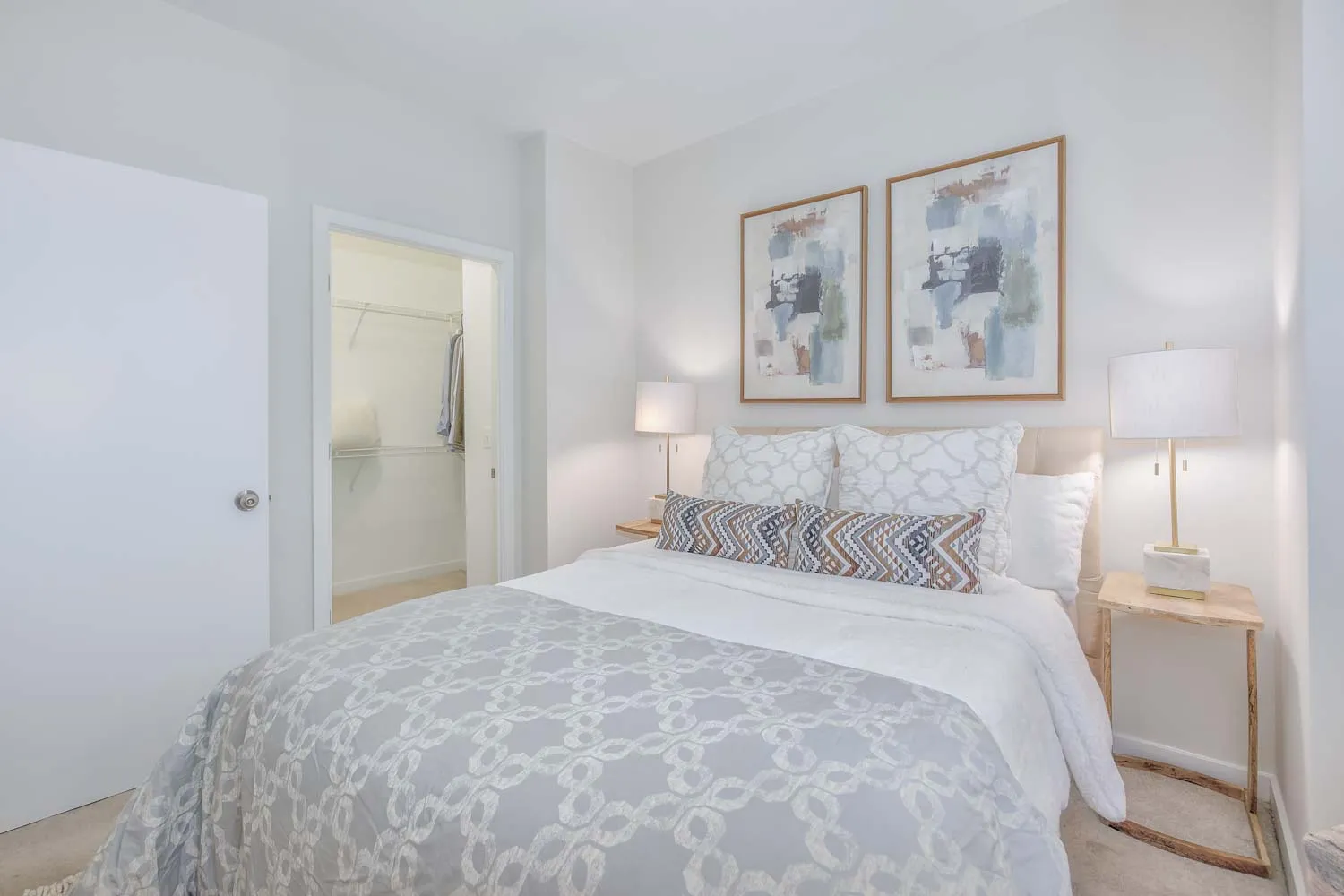 a bedroom with a bed and painting on the wall