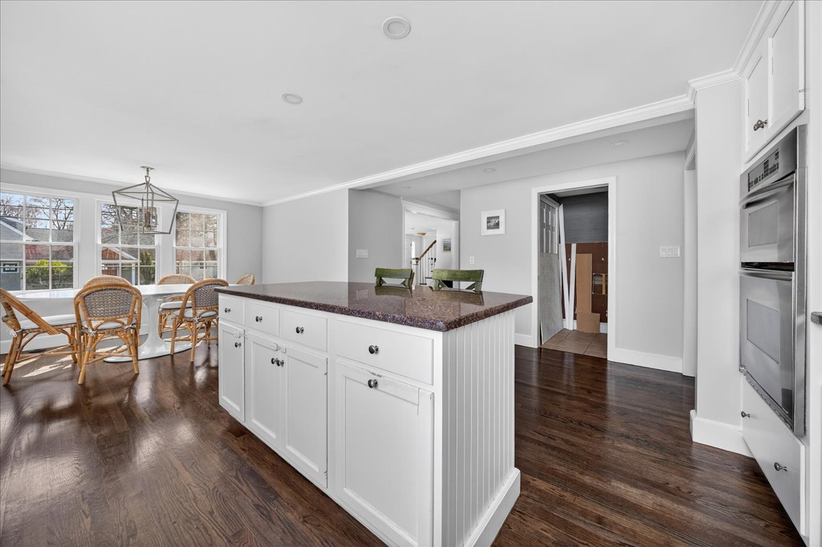 6 Studley Road Hingham, MA 02043 - Photo 10 of 27 a kitchen with granite countertop cabinets a dining table and a stove top oven