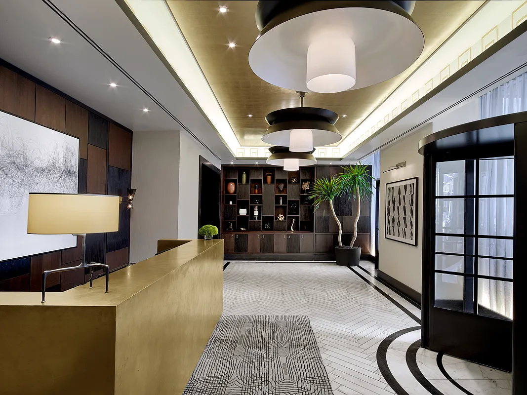100 Barclay Street, Unit 21AD Manhattan, NY 10007 - Photo 23 of 37 a lobby with furniture and a chandelier
