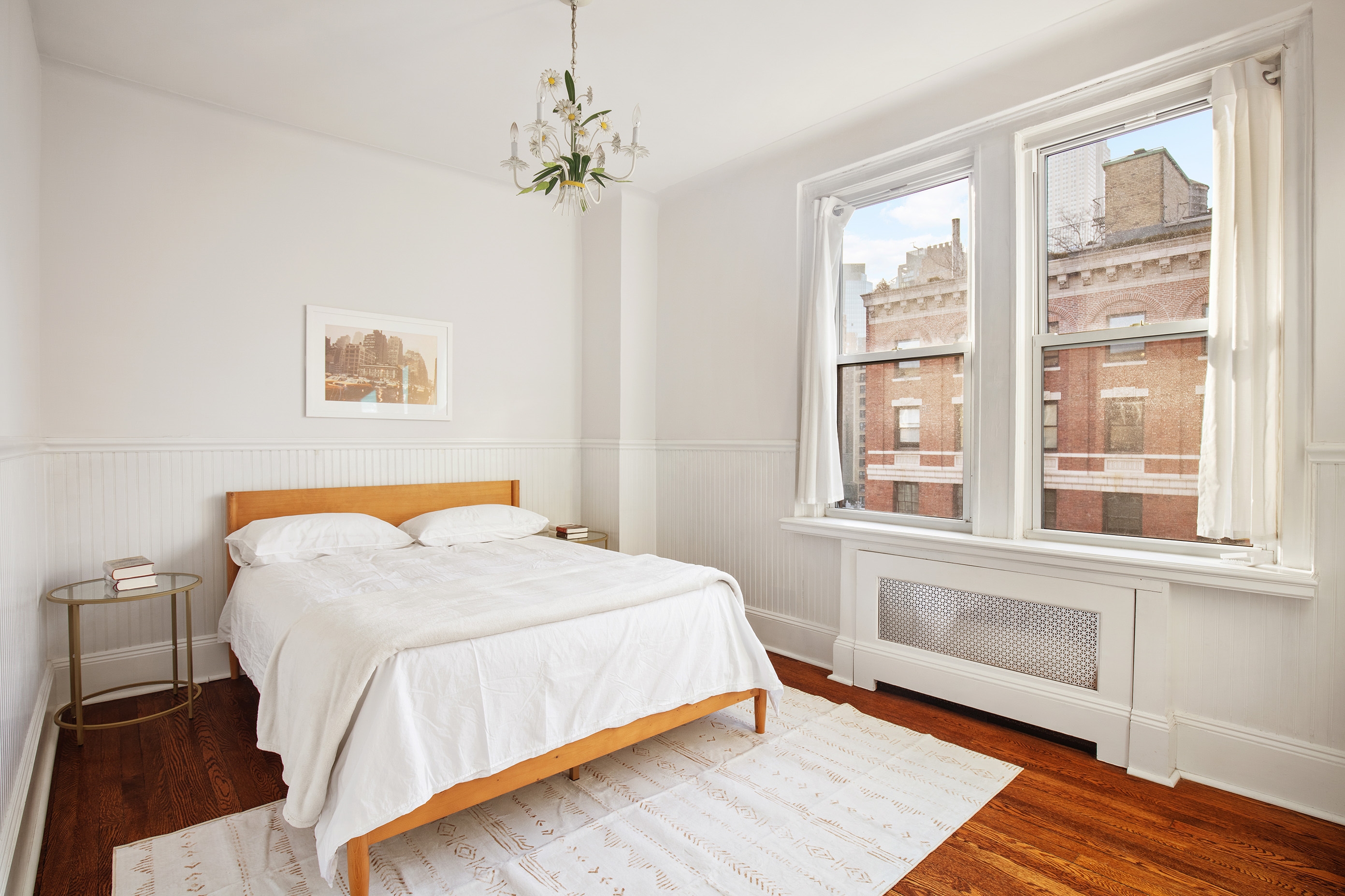 136 East 36th Street, Unit 9/10C Manhattan, NY 10016 - Photo 12 of 16 a bedroom with a bed and a window