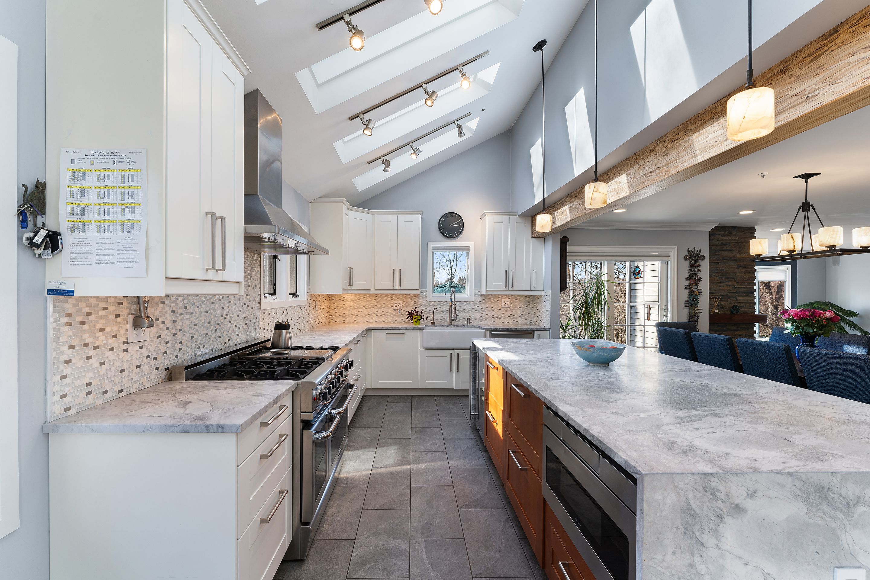 124 Boulder Ridge Road Scarsdale, NY 10583 - Photo 4 of 31 a kitchen with stainless steel appliances granite countertop a sink stove and cabinets