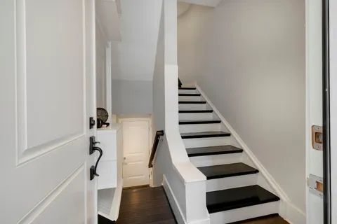 a view of entryway and hall with wooden floor
