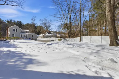 a view of roof covered with snow in front of house