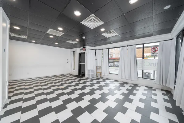 a bathroom with a black and white checkered floor
