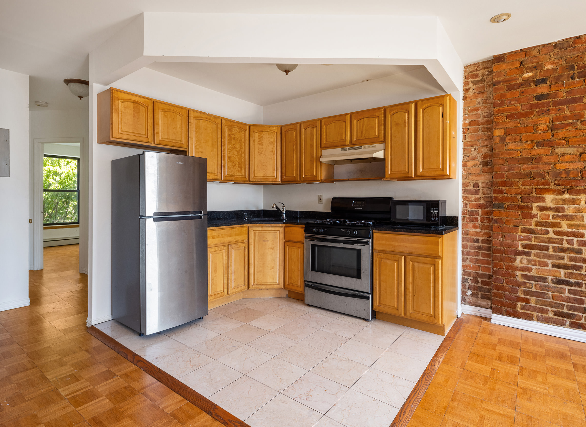 37 Quincy Street Brooklyn, NY 11238 - Photo 16 of 24 a kitchen with granite countertop a refrigerator and a stove top oven