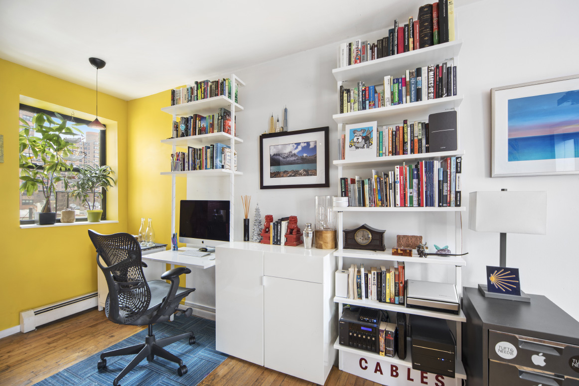 319 East 105th Street, Unit 5A Manhattan, NY 10029 - Photo 2 of 13 a work room with furniture and a book shelf
