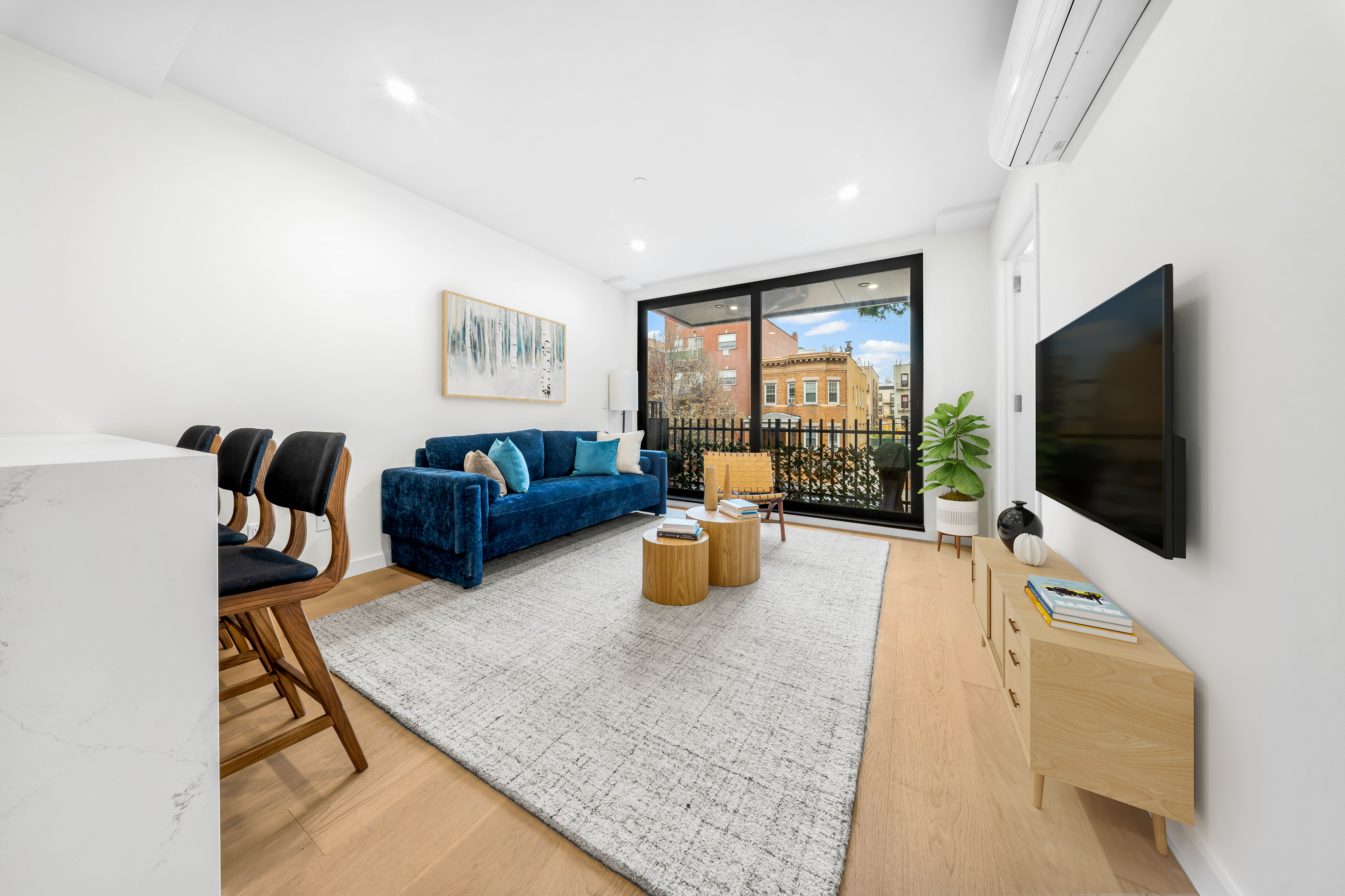 30-24 32nd Street, Unit 3A Queens, NY 11102 - Photo 8 of 18 a living room with furniture and a flat screen tv