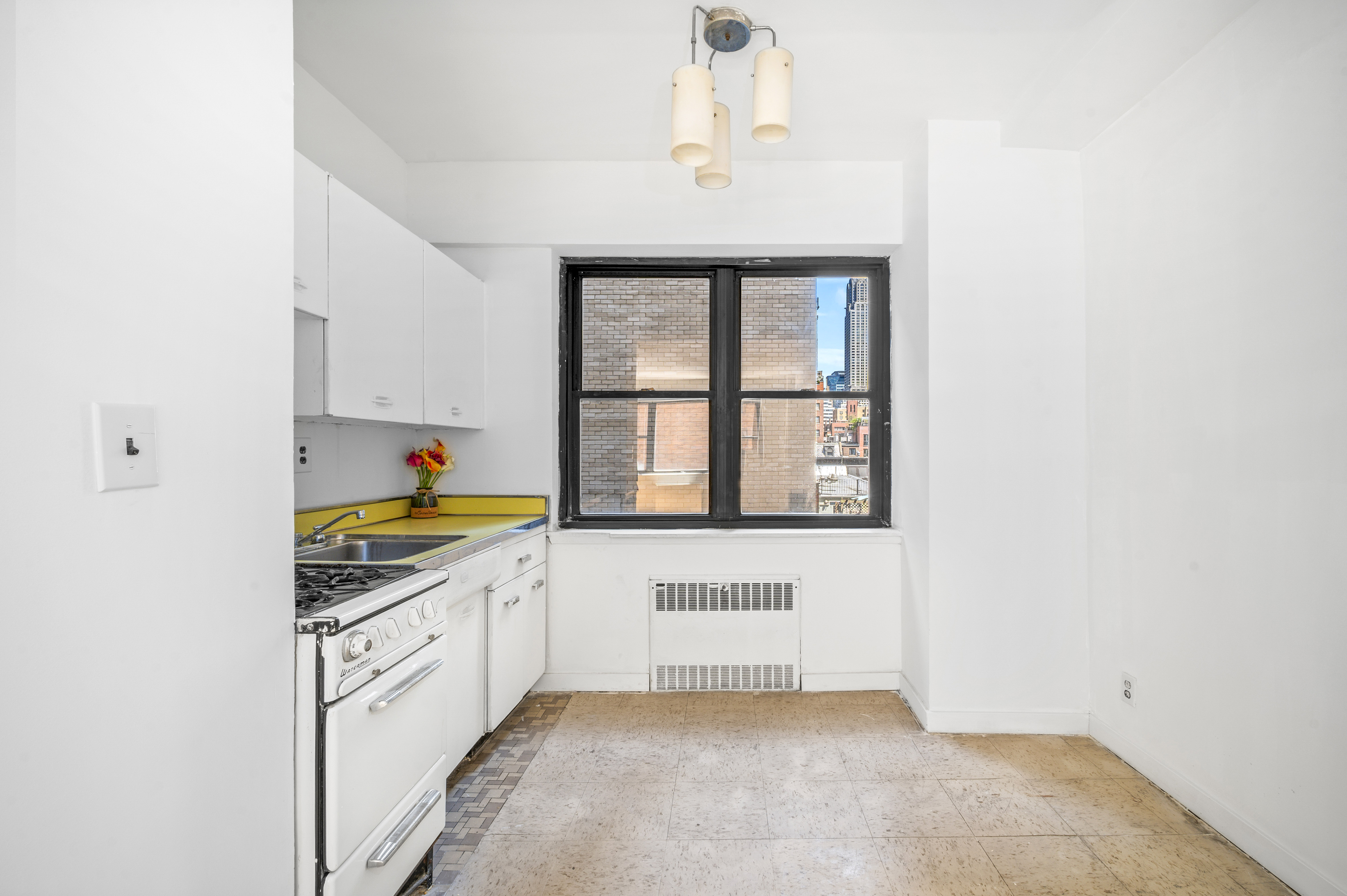 7 Park Avenue, Unit 66 Manhattan, NY 10016 - Photo 4 of 11 a kitchen with granite countertop a sink stainless steel appliances and cabinets