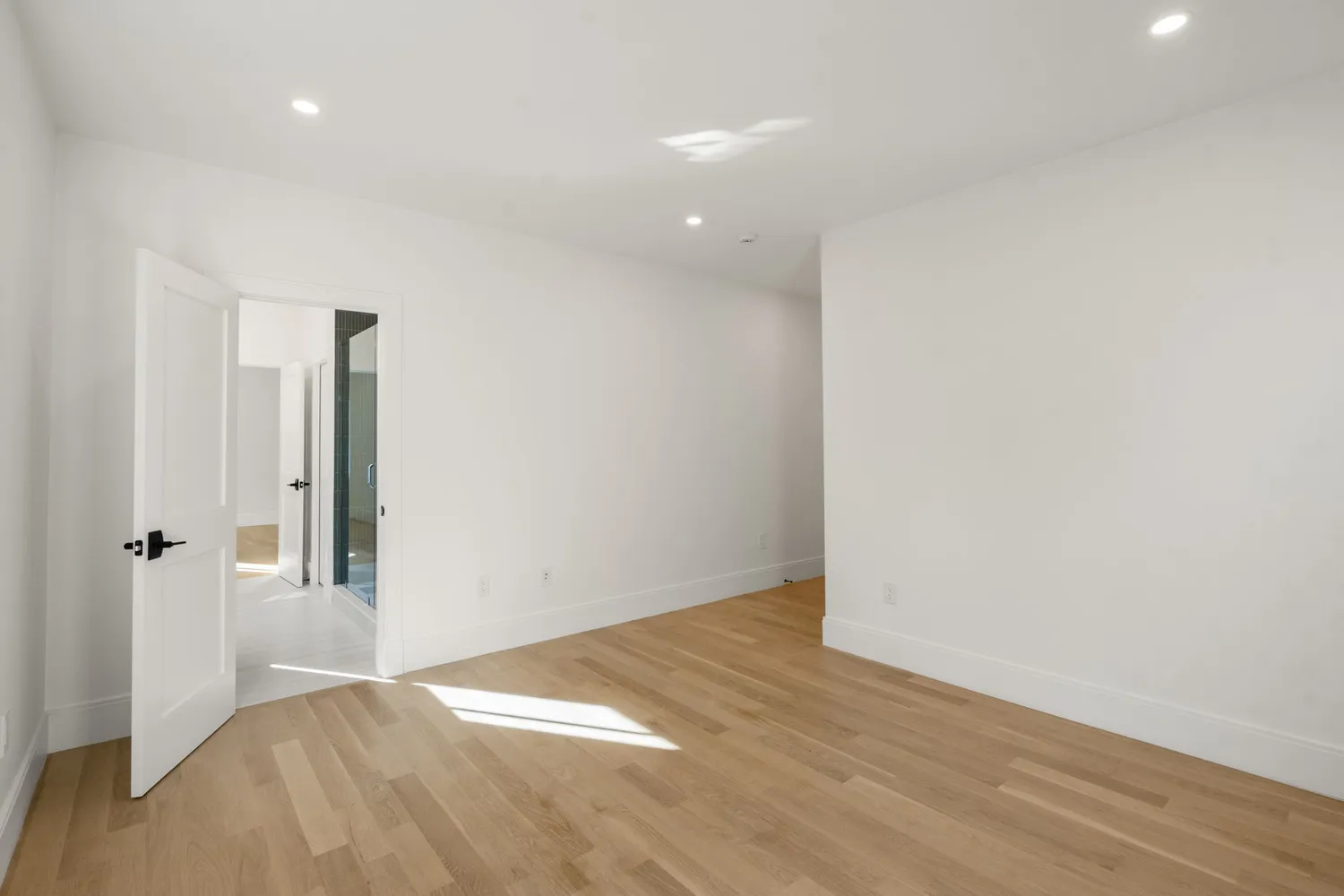 a view of hallway with wooden floor