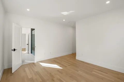 a view of hallway with wooden floor