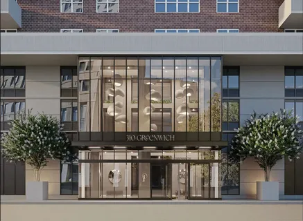 a front view of a building with a garden