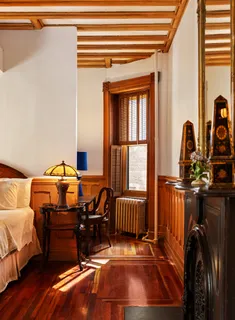 a room with furniture a rug and a window