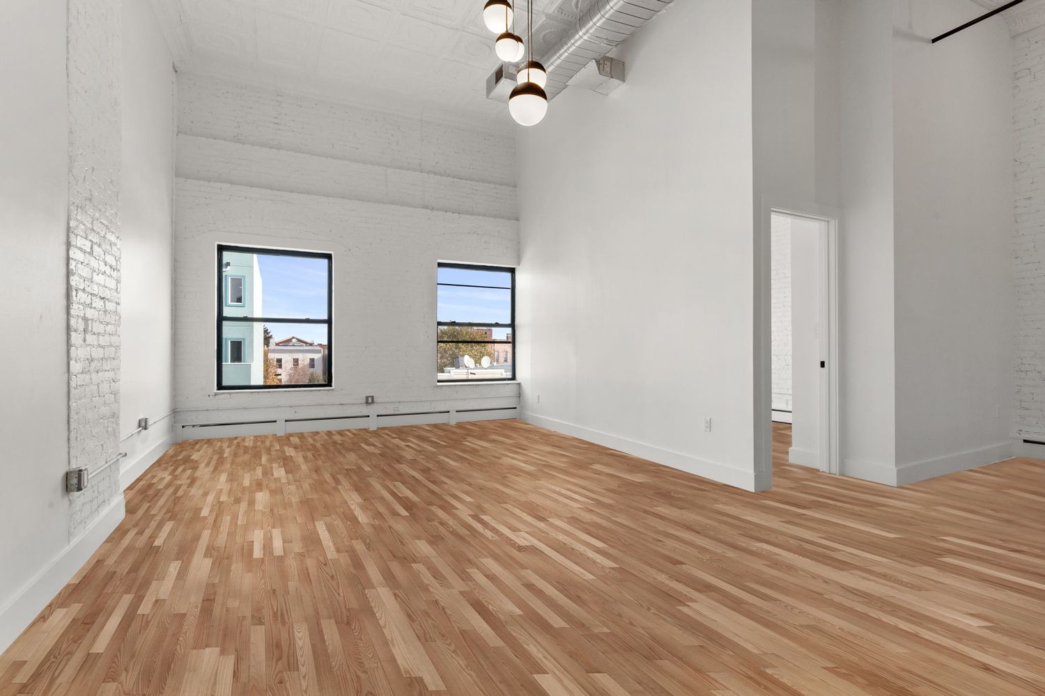 717 Manhattan Avenue, Unit 2A Brooklyn, NY 11222 - Photo 4 of 17 a view of empty room with wooden floor and fan