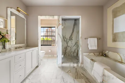a spacious bathroom with a double vanity sink toilet and shower