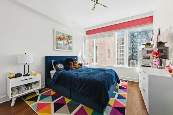 a bed room with a bed and a chair