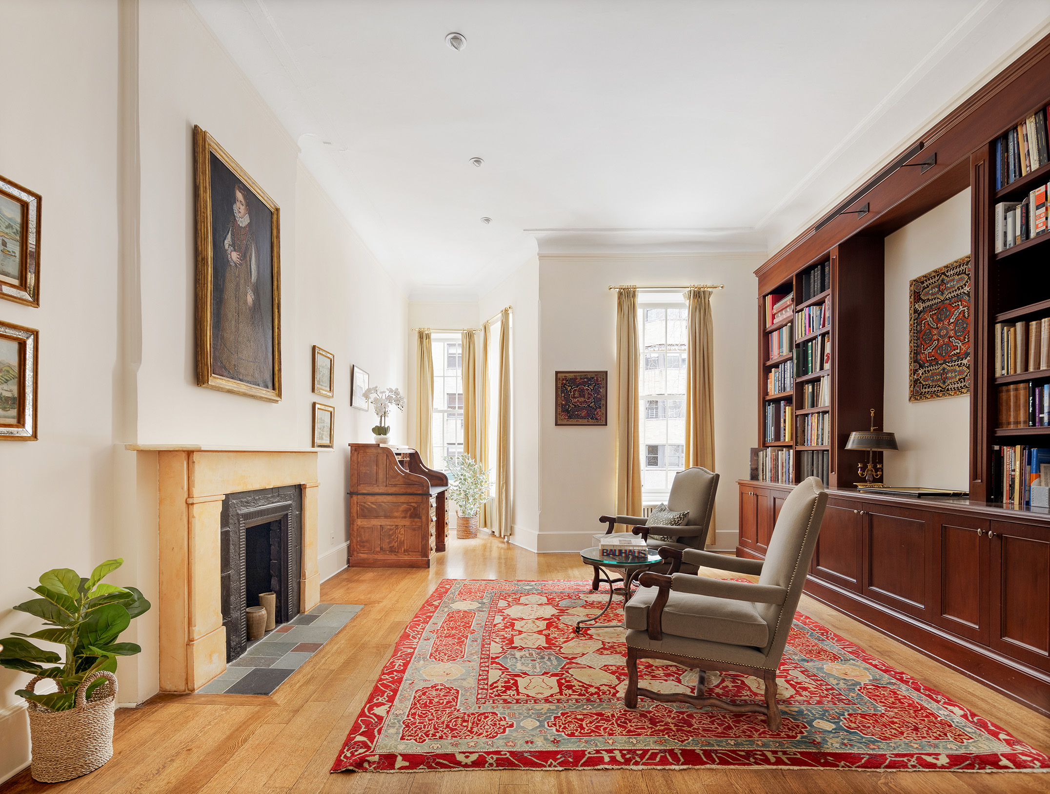 129 East 81st Street Manhattan, NY 10028 - Photo 9 of 17 a living room with furniture fireplace and a table