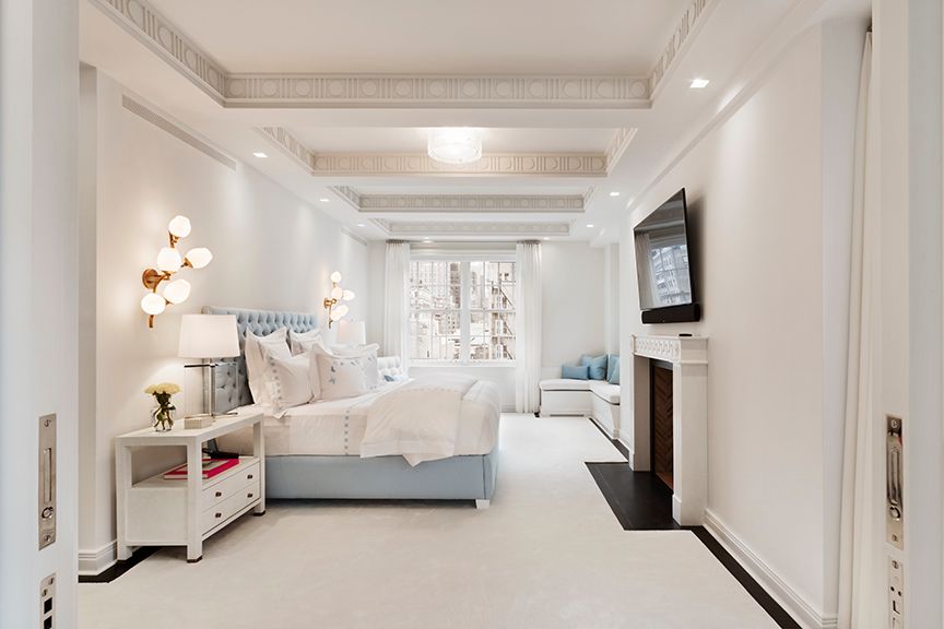 a spacious bedroom with a bed couch and a window