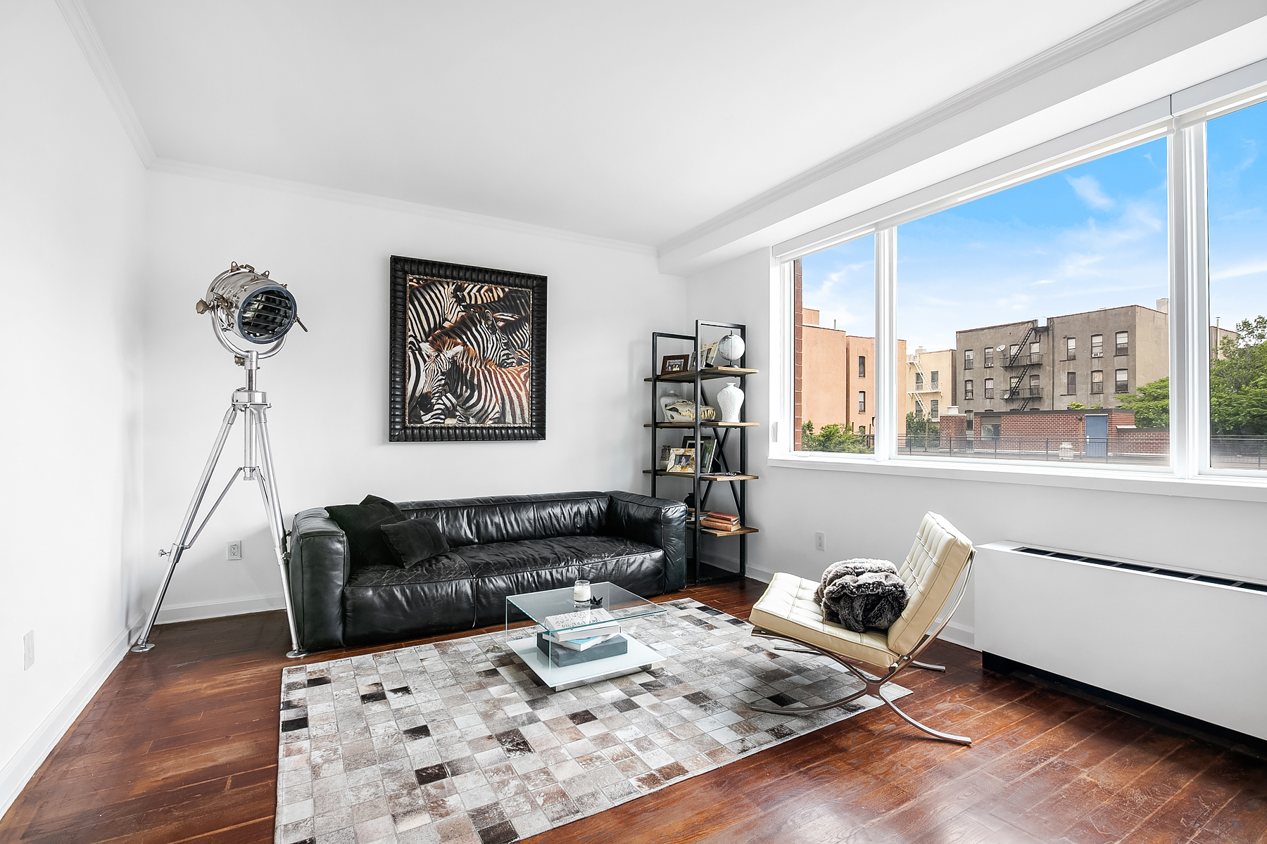 32 West 128th Street, Unit 4 Manhattan, NY 10027 - Photo 2 of 11 a living room with furniture and wooden floor