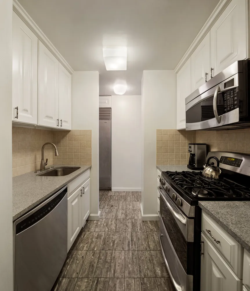 a kitchen with stainless steel appliances granite countertop a stove and a refrigerator