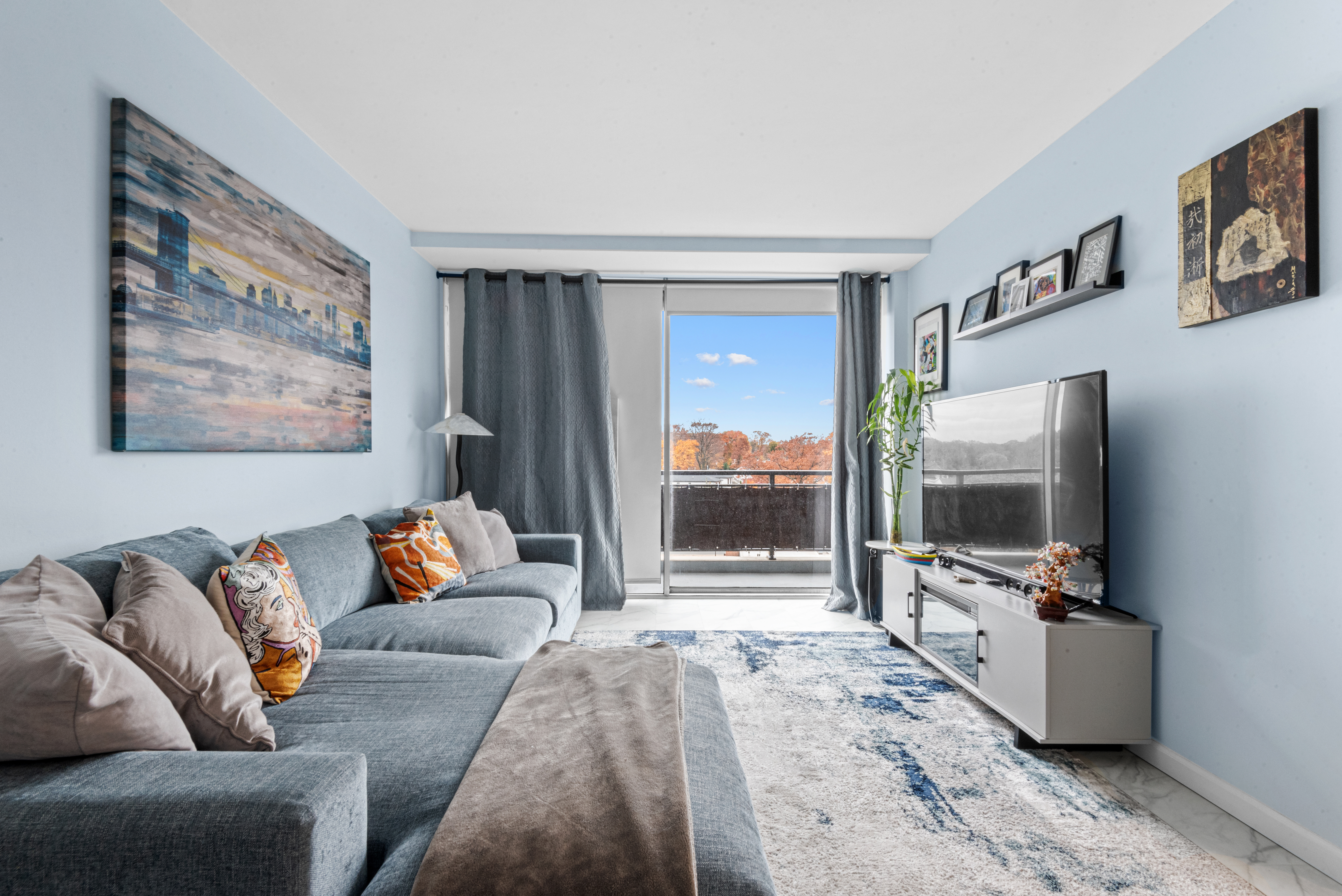 4 Horizon Road, Unit 1013 Fort Lee, NJ 07024 - Photo 4 of 18 a living room with furniture and a flat screen tv