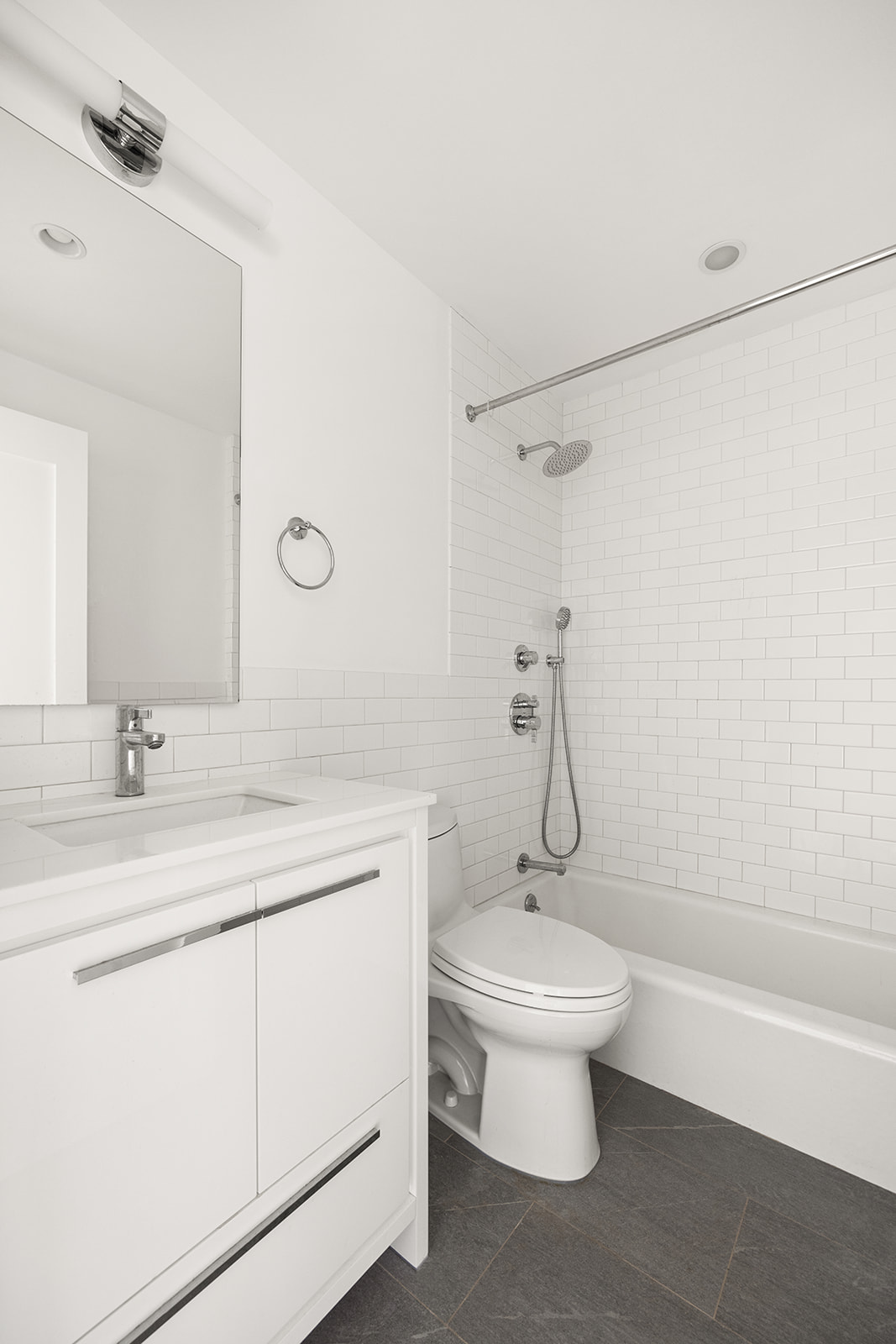 230 Baltic Street, Unit 2 Brooklyn, NY 11201 - Photo 8 of 11 a bathroom with a granite countertop toilet a sink and a mirror