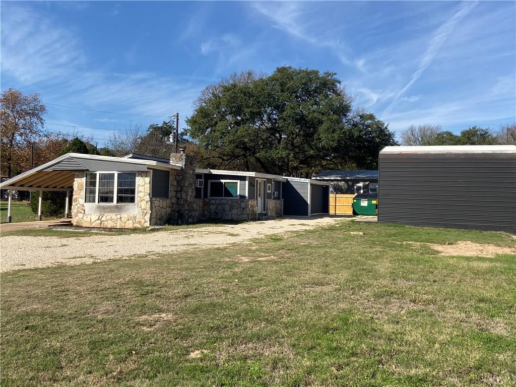 8518 Ranch To Market Road 1826 Austin, TX 78737 - Photo 2 of 17 a backyard of a house with large trees and outdoor space