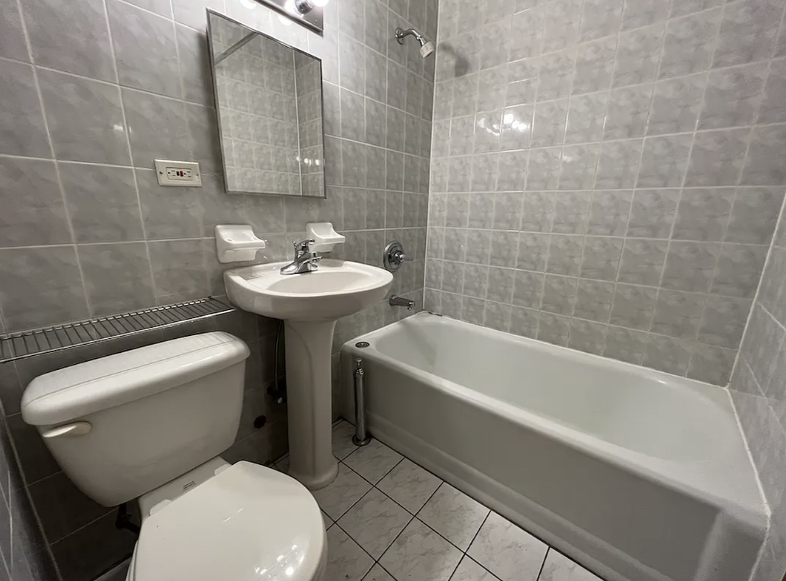 446 West 46th Street, Unit 12 Manhattan, NY 10036 - Photo 11 of 18 a bathroom with a sink a toilet and bathtub
