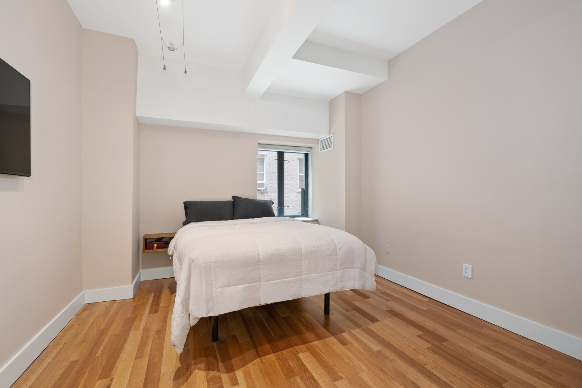 135 West 70th Street, Unit 4A Manhattan, NY 10023 - Photo 5 of 7 a bedroom with a bed and wooden floor