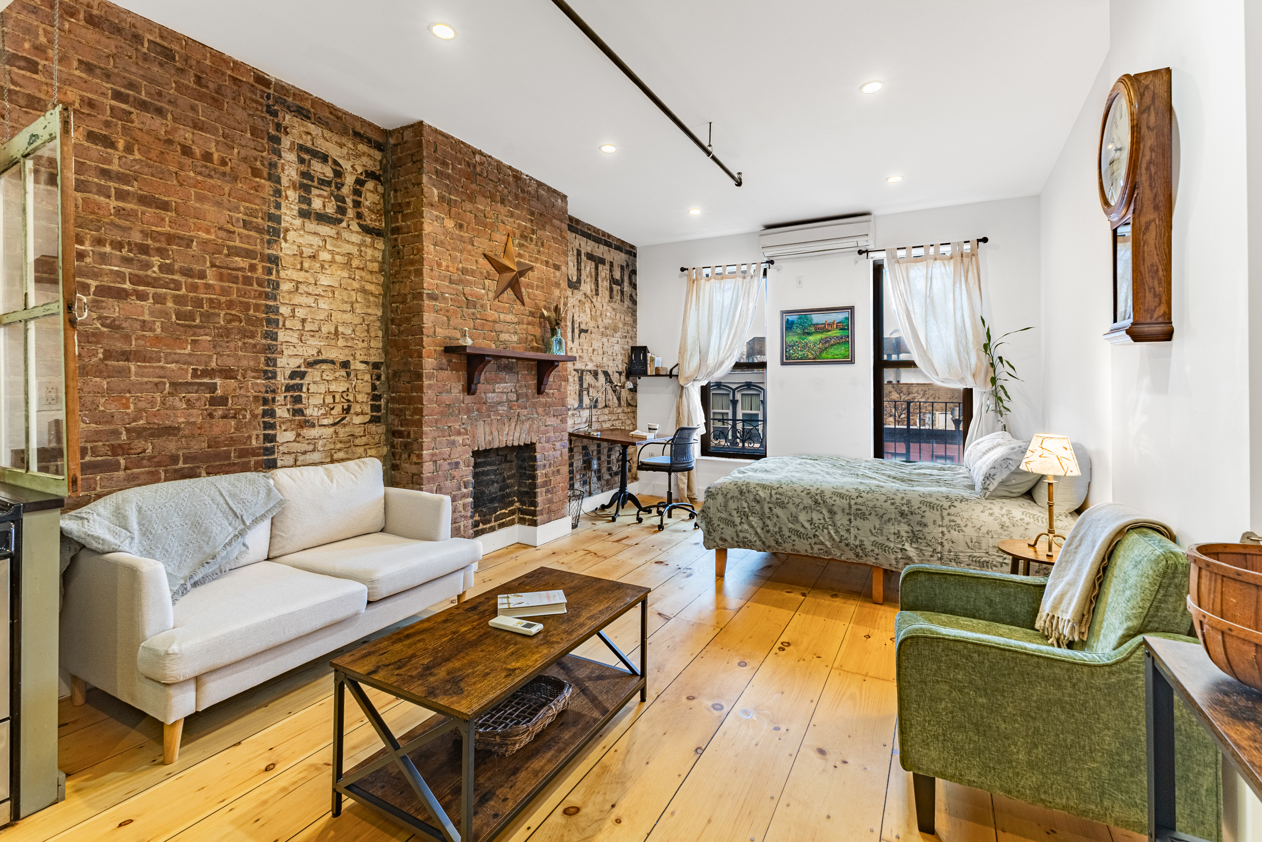 a living room with fireplace furniture and a rug