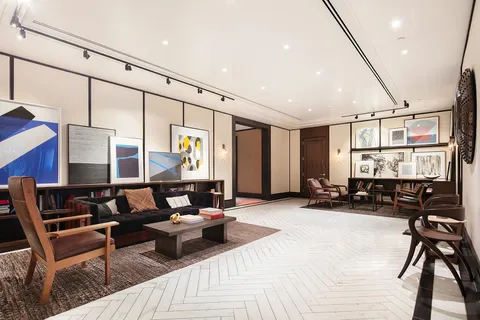 a living room with furniture a rug and white walls