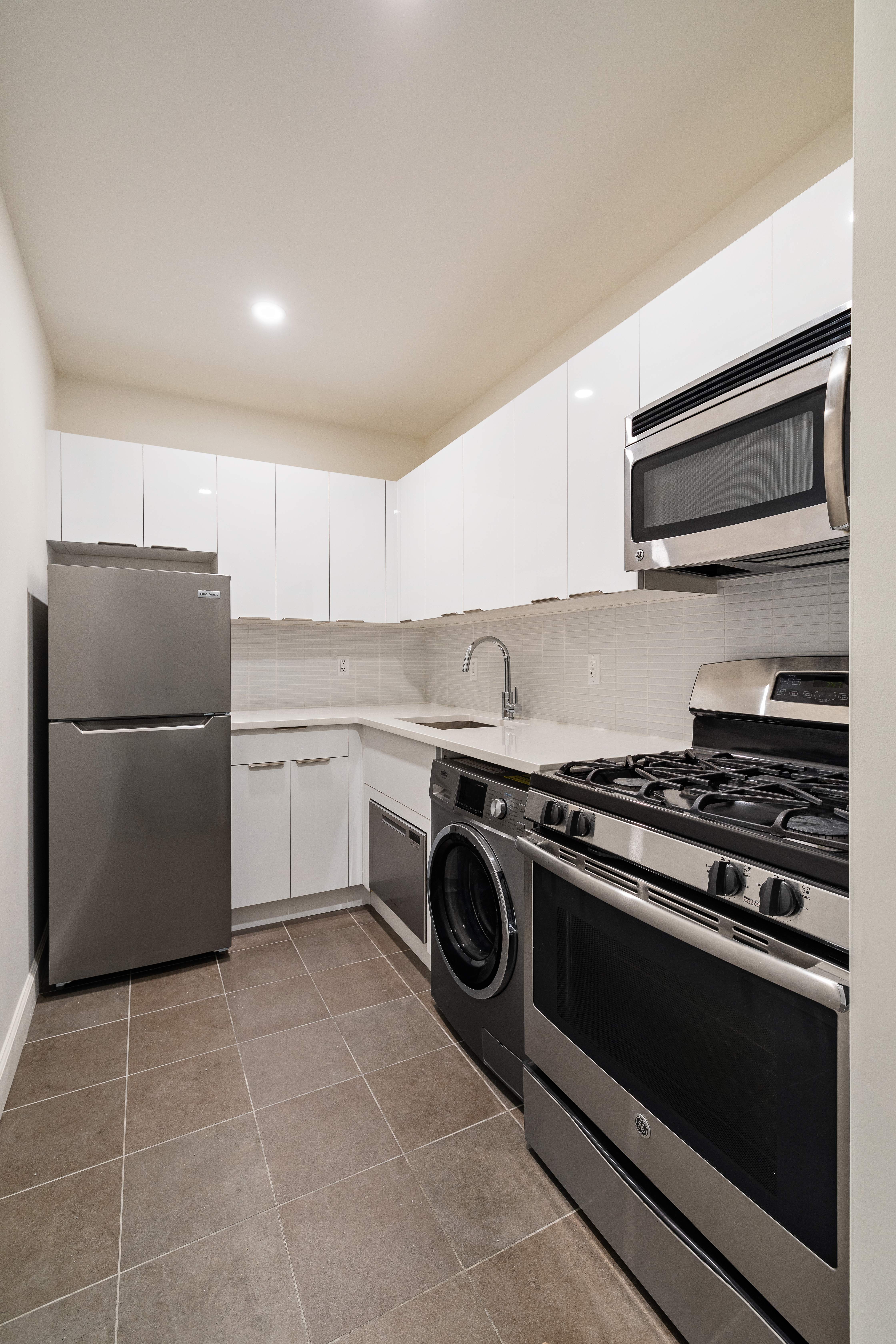 194 East 2nd Street, Unit 5L Manhattan, NY 10009 - Photo 6 of 12 a kitchen with a stove and a refrigerator