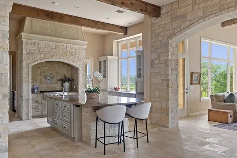 a living room with furniture a fireplace and a table