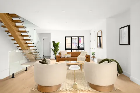 a living room with furniture and white walls