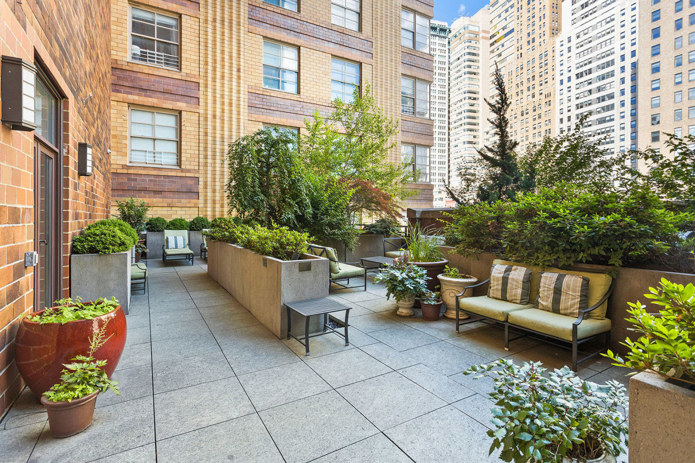 20 West Street, Unit 9A Manhattan, NY 10004 - Photo 8 of 14 a building outdoor space with patio furniture and potted plants