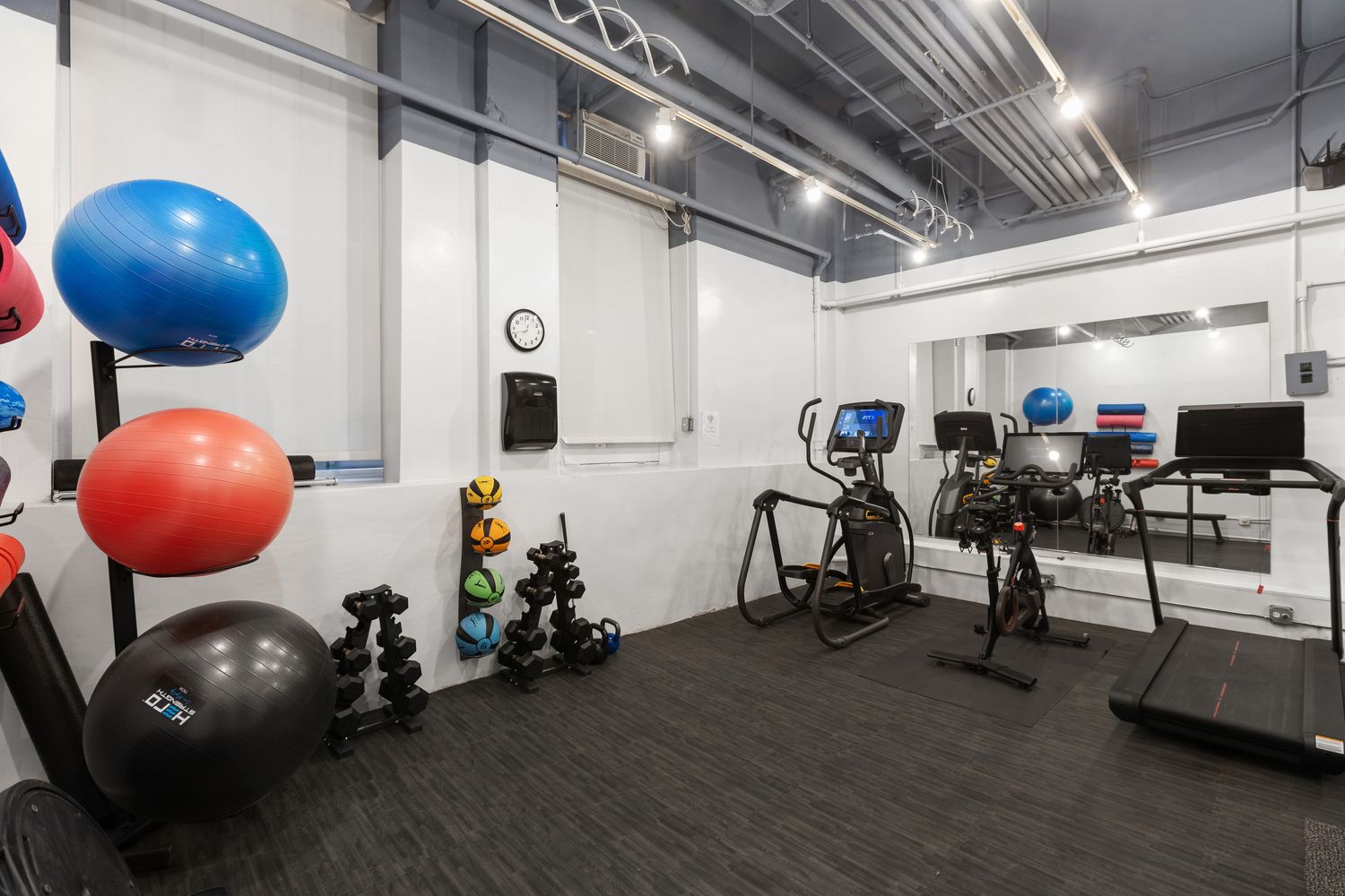 50 Central Park West, Unit 8BB Manhattan, NY 10023 - Photo 21 of 28 a room with wooden floor and gym equipment