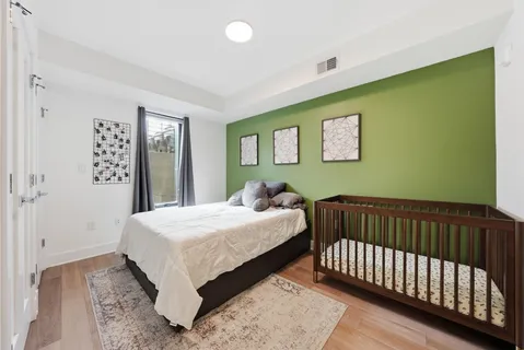 a bedroom with a bed and painting on the wall